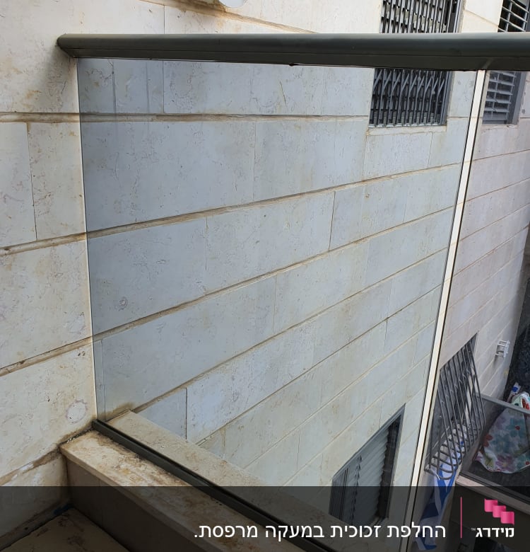 מעקה זכוכית עם מסגרת מתכת על מרפסת